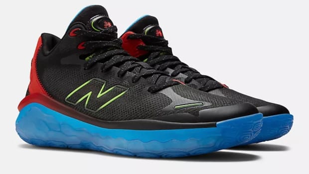View of black, red, and blue New Balance shoes.